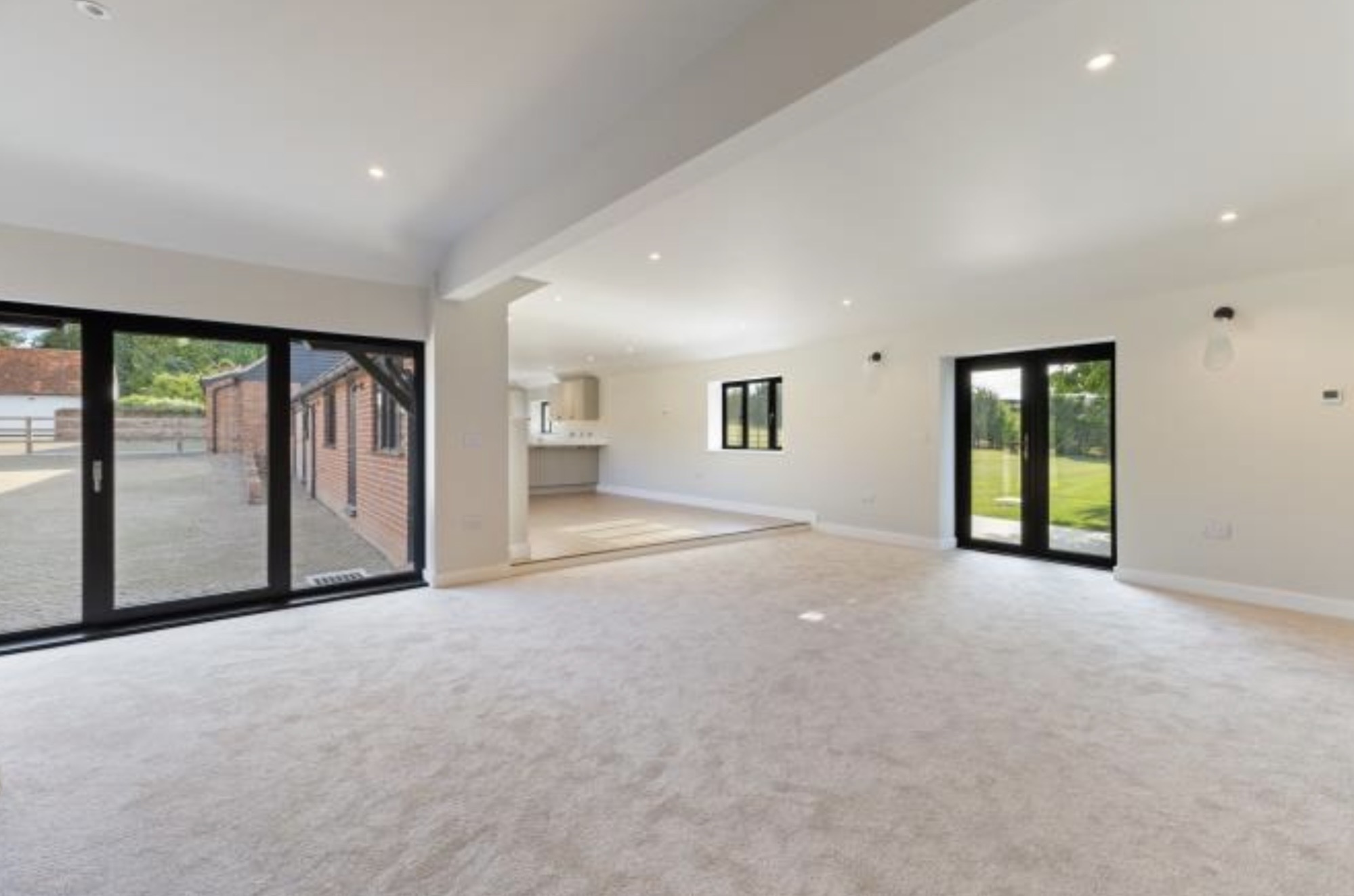 Bright reception room with bi-fold doors in Thaxted barn conversion
